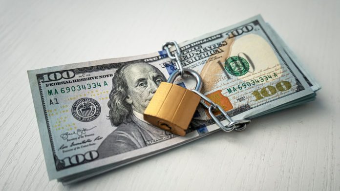 New-Publishers-Clearing-House-CEO-vows-to-protect-future-prizes A stack of 100 dollar bills padlocked
