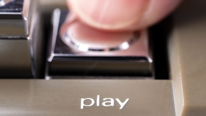 ProgressPlay-Debut-Sweepstakes-Casino-Platform-US A person presses the play button as ProgressPlay plans to launch a sweepstakes platform.