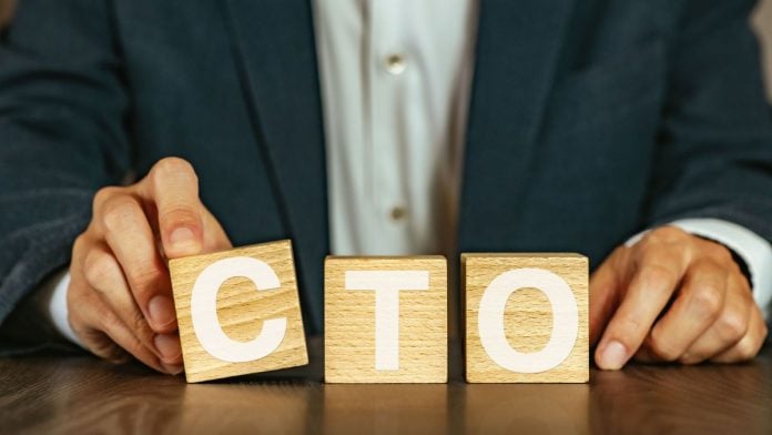 Rush-Street-Interactive-appoints-ex-Warner-Bros-exec-as-CTO A person holding wooden blocks spelling out CTO, short for Chief Technology Officer