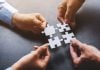 Puzzle pieces as two social gaming groups combine forces.