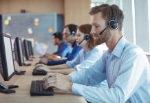 States highlight own problem gambling supports amid 1-800-GAMBLER transition Several people sitting in line at a desk using phone headsets