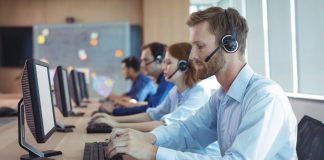 States highlight own problem gambling supports amid 1-800-GAMBLER transition Several people sitting in line at a desk using phone headsets