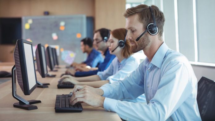 States-highlight-own-problem-gambling-supports-amid-1-800-GAMBLER-handover Several people sitting in line at a desk using phone headsets
