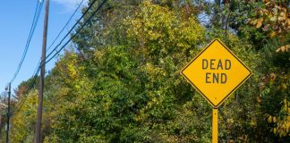 Titus’ attempt to add FAIR BET Act to defense bill goes nowhere A Dead End road sign in front of a background of trees