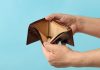 Gambling tax deduction paper with empty wallet.