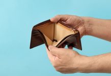 Gambling tax deduction paper with empty wallet.