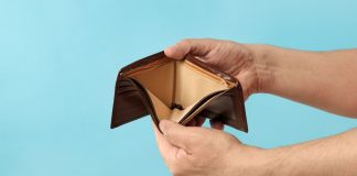 Gambling tax deduction paper projects $18B handle losses for sportsbooks Gambling tax deduction paper with empty wallet.