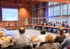 People gathered at a table for a business presentation