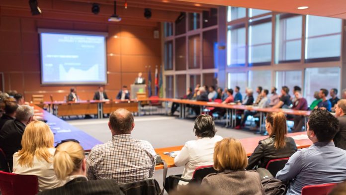 Aristocrat-takes-seat-at-UNLV-gaming-AI-research-table People gathered at a table for a business presentation