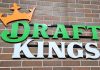 The DraftKings logo against a brick wall