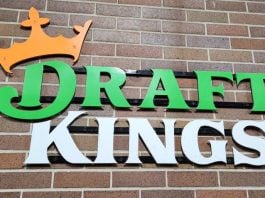 The DraftKings logo against a brick wall