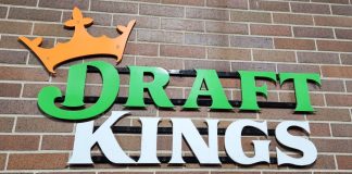 The DraftKings logo against a brick wall