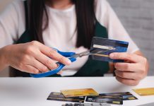 Illinois lawmakers want to make gambling with credit cards illegal A woman cutting up her credit cards