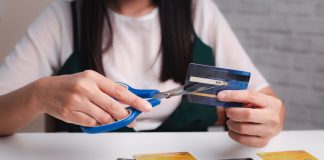 Illinois lawmakers want to make gambling with credit cards illegal A woman cutting up her credit cards