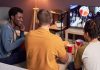 A group of friends watches sports like bettors would do.