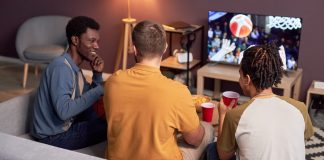 A group of friends watches sports like bettors would do.