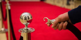MA regulators consider rules around VIP sportsbook host compensation Hand opening velvet rope