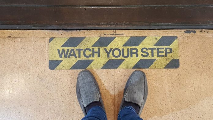 Michigan-regulator-warns-operators-to-keep-distance-from-event-contracts A warning sign telling people to watch their step