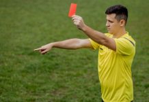 Soccer referee with penalty marker as Super Group faces a monetary penalty in New Jersey.