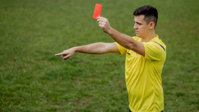 Soccer referee with penalty marker as Super Group faces a monetary penalty in New Jersey.