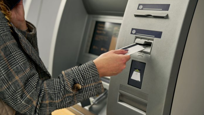 A person at an ATM as Pavilion Payments brings its services to three tribal casinos in Oklahoma.
