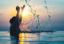 A person splashes water as Splash Sports raises new funding.