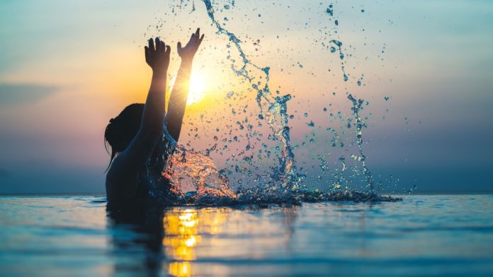 A person splashes water as Splash Sports raises new funding.