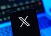 Better Collective teams up with X to launch AI-powered tool Playbook X on a person's phone after signing the social media platform secured a deal with Better Collective.