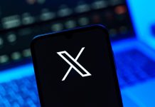 Better Collective teams up with X to launch AI-powered tool Playbook X on a person's phone after signing the social media platform secured a deal with Better Collective.