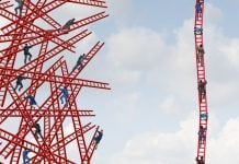 People climb a ladder next to others that are crashed