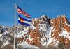 Colorado fines BetMGM $50K for taking $880 in college player props The flags of the U.S. and Colorado flying in front of snowy brown mountains