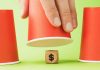 Money wooden block under cup game