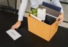 FanDuel and DraftKings split with AGA over prediction markets debate An employee with a box of packed-up possessions placing a resignation letter on a desk