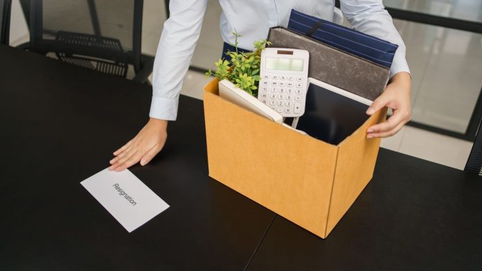 FanDuel-and-DraftKings-split-with-AGA-over-prediction-markets-debate An employee with a box of packed-up possessions placing a resignation letter on a desk