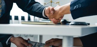 Florida reconsiders making gambling with insider info a felony Men shake hands as Florida lawmakers consider a measure that criminalizes sports bribes.