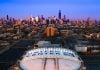 Aerial view of the United Center with the Chicago skyline in the background