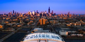 Illinois bets fall 15% year over year as customer surcharges hit Aerial view of the United Center with the Chicago skyline in the background