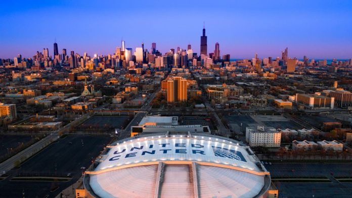 Aerial view of the United Center with the Chicago skyline in the background