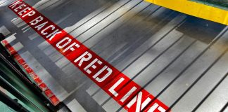 Maryland regulator warns operators to stay out of sports predictions A sign on the floor warning people to stay behind the red line