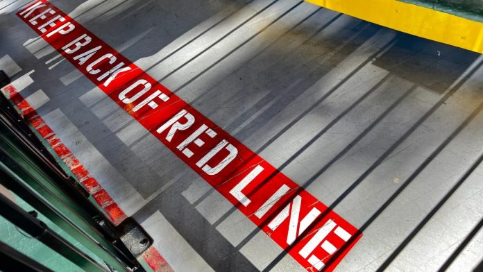 Maryland-regulator-warns-operators-to-stay-out-of-sports-prediction-markets A sign on the floor warning people to stay behind the red line