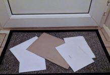 Unopened mail lying on a doormat