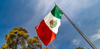 Mexico close to hiking gambling tax to 50% after Senate approval The flag of Mexico flying above trees in the sunshine