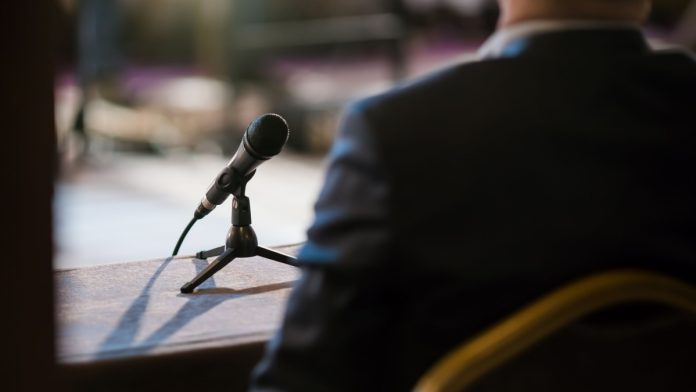 Person with a mic as Michael Selig undergoes the nomination process for CFTC Chair.