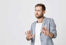 A man telling the camera to stay back