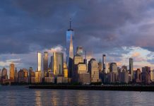The skyline of Manhattan, New York City under dark purple clouds