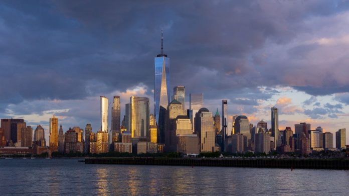 The skyline of Manhattan, New York City under dark purple clouds