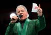 Polymarket mimics sportsbook odds integrations with UFC deal A UFC announcer holding a UFC-branded microphone and card before a fight