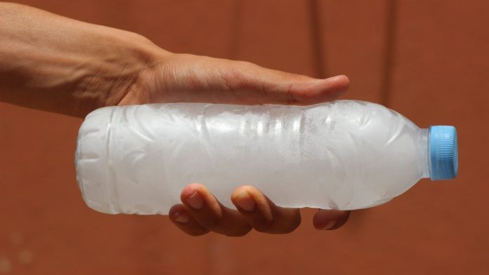 Robinhood-freezes-sports-contracts-in-Nevada,-pending-appeal A person holding a water bottle full of frozen water turned to ice