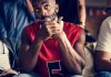 YouGov survey finds Americans lack trust in sporting integrity Basketball fans looking skeptical while watching a game