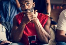 Basketball fans looking skeptical while watching a game